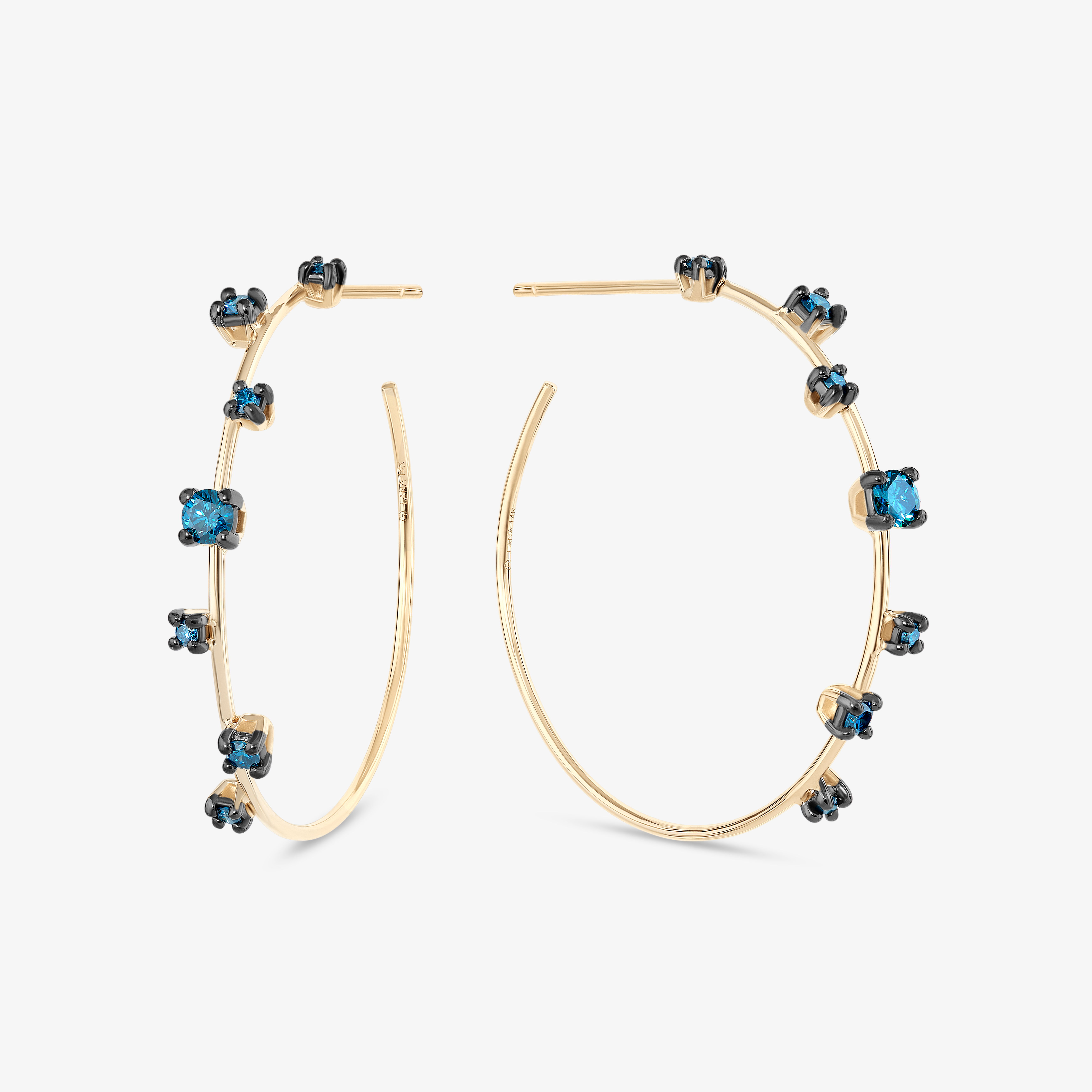 Gold hoop earrings with blue gemstones.