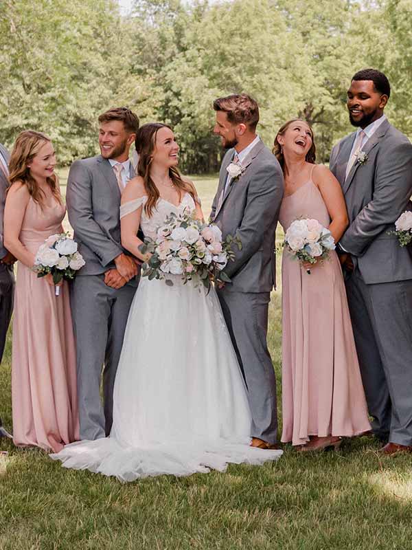 The happy bride and groom on their wedding take, taking a photo with their wedding party