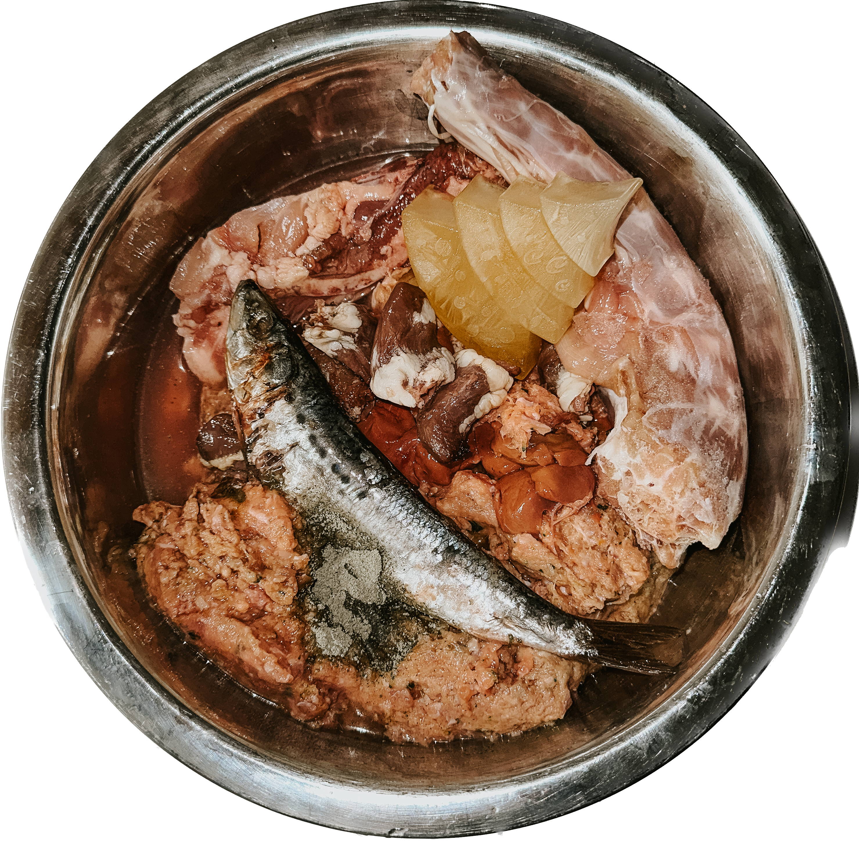 Silver dog bowl filled with raw meat, bones, supplements, and a sardine.