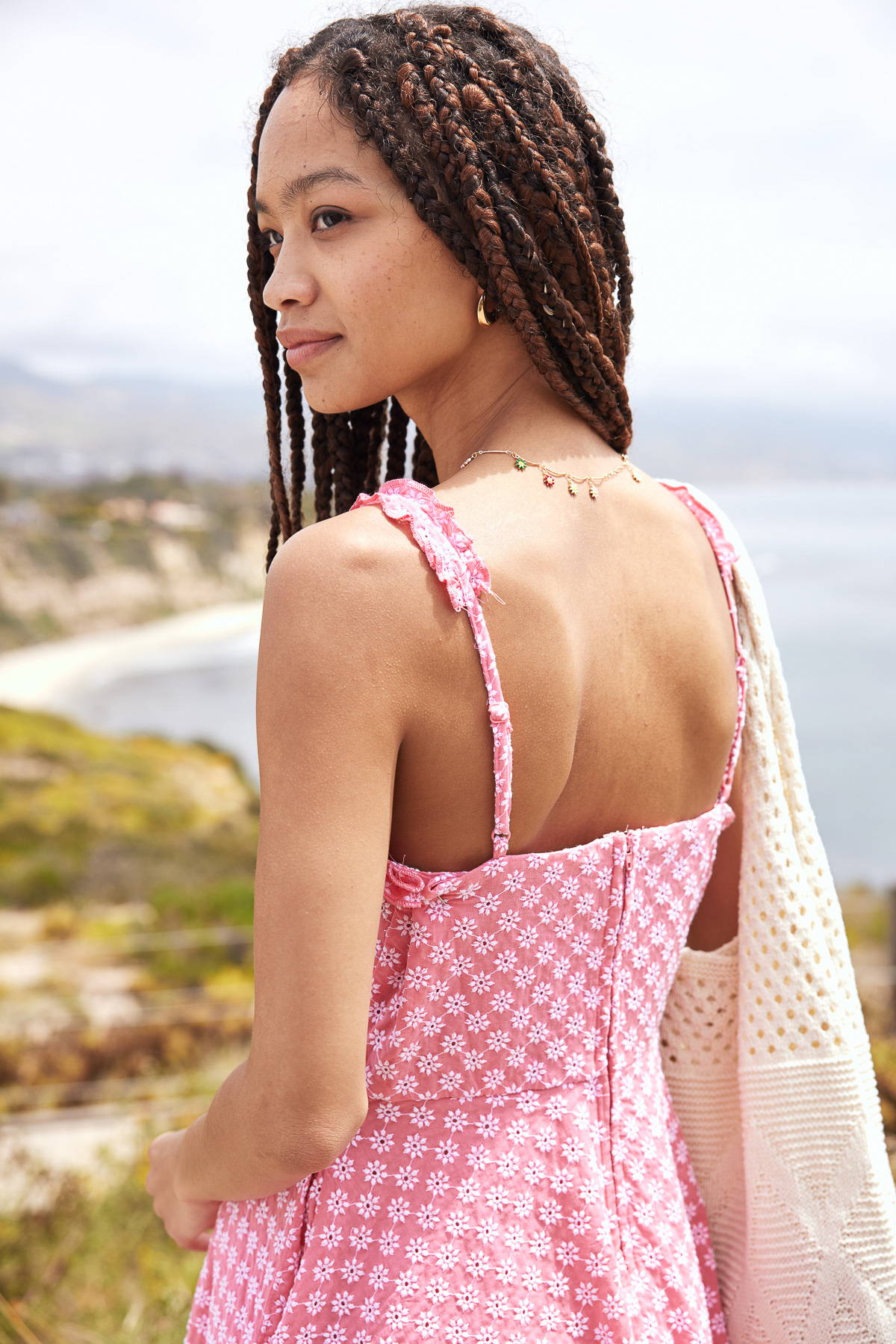 Trixxi sun-kissed summer, girl at oceanside beach cliff in a pink embroidered tank skater dress.