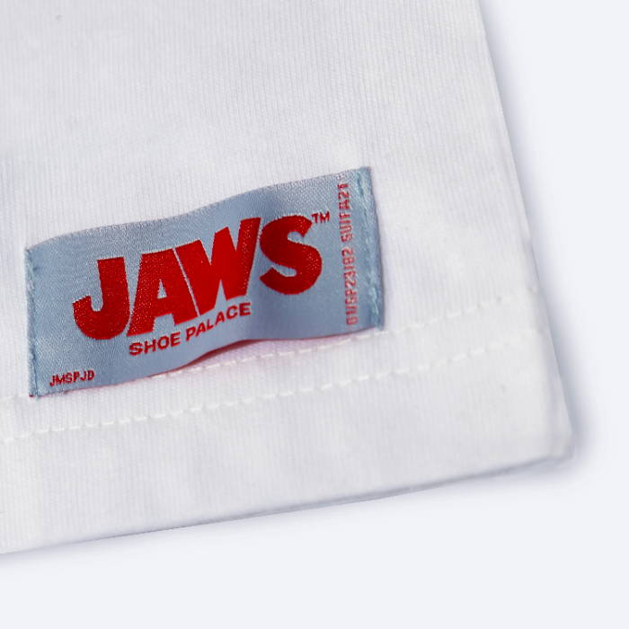 closeup of jaws tag on white shirt