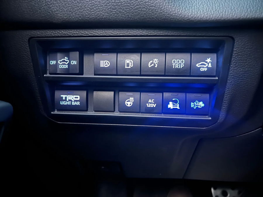 Dashboard auxiliary switch panel horn button glowing blue bed power outlet Brandon's Tundra i-FORCE MAX TRD Pro K5LA 544 cabin install gallery photo 4