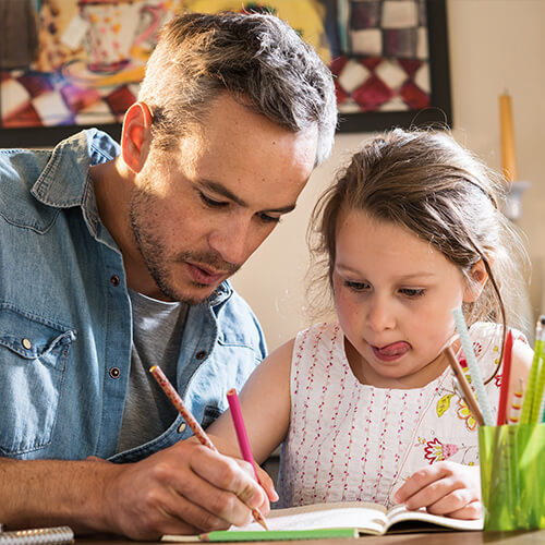 Parent helping child with family engagement activity