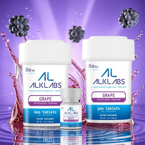 Two bottles of ALKLABS grape tablets with splash effect and berries.
