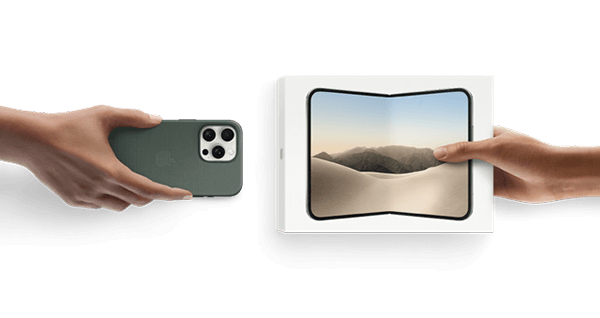 Two hands exchanging a smartphone and a box with a landscape image.