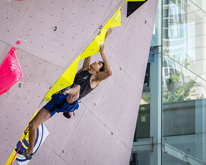 Jesse Grupper on climbing wall