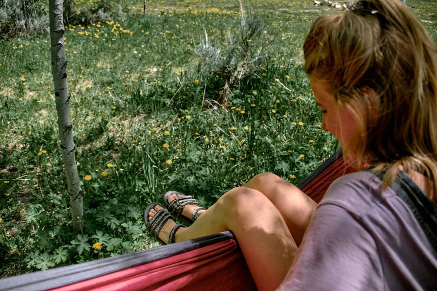 woman wearing vegan sandals in hammock