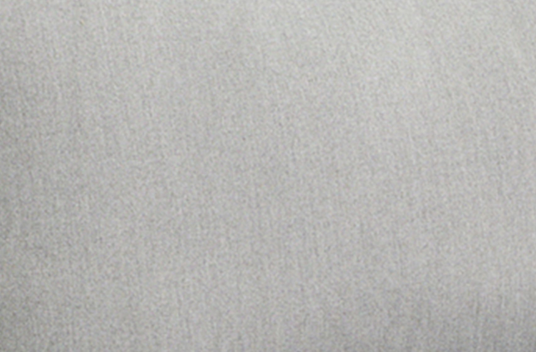 Close-up of textured light gray fabric background.
