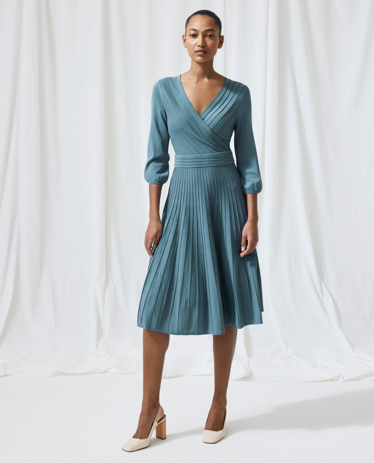 Model wearing lake blue Belluno dress