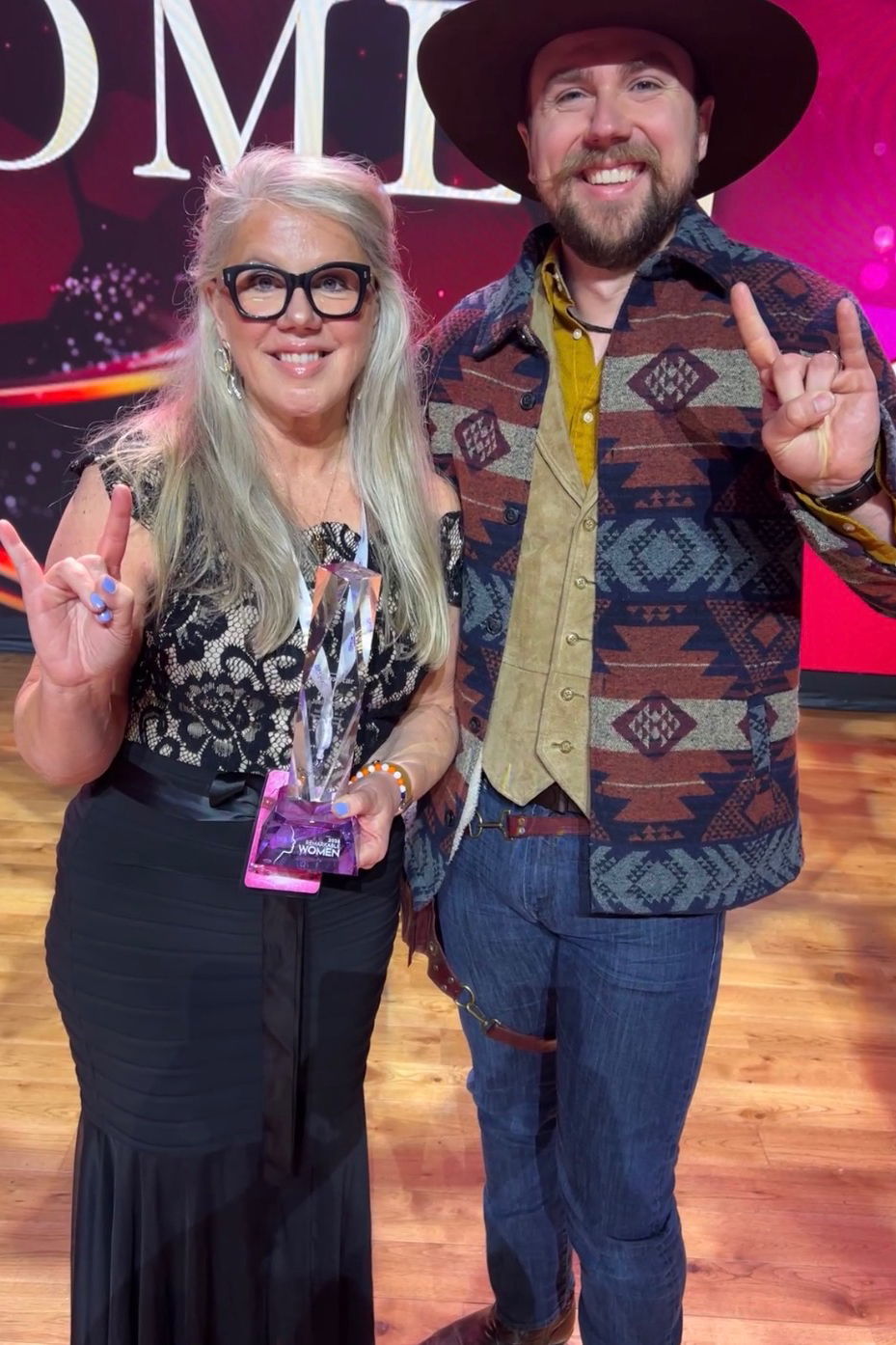 Joell receiving her Remarkable Woman award with her son.