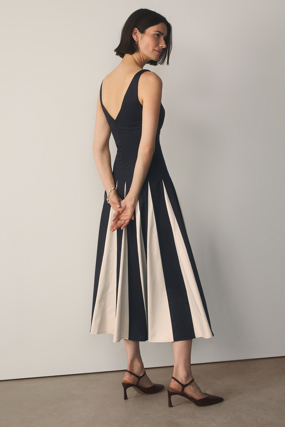 Model wearing navy and stone Salina dress
