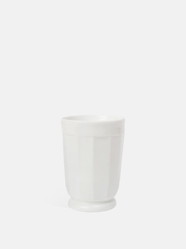 A milk glass panelled tumbler in milk white.