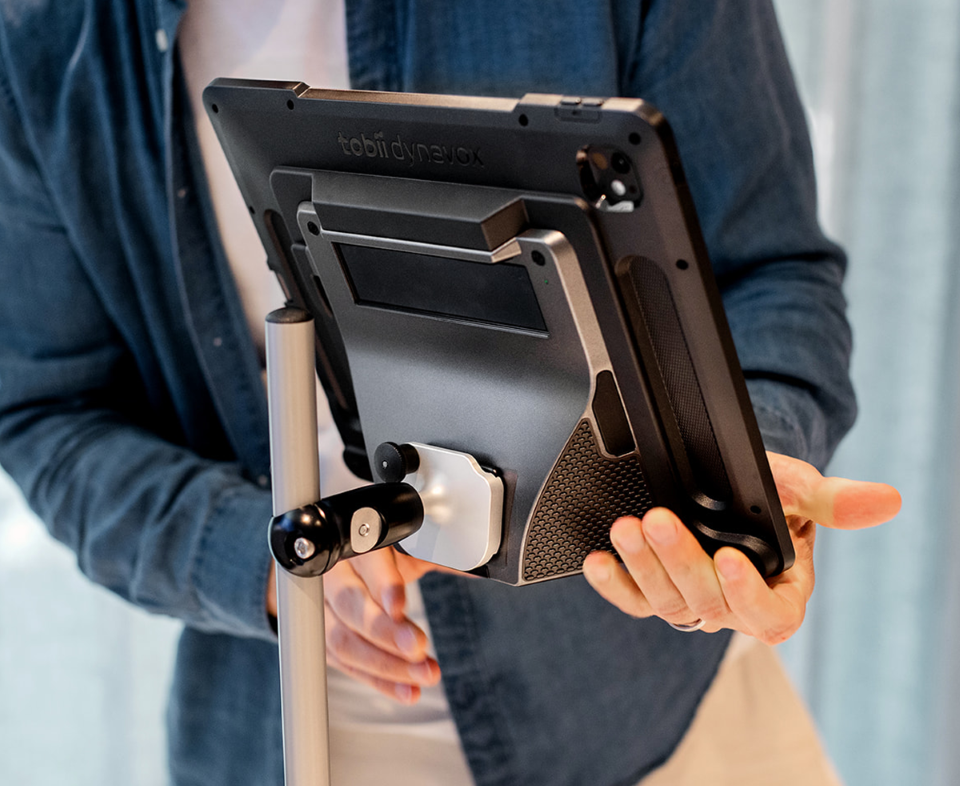 Man mounting a communication device to an AAC mounting system