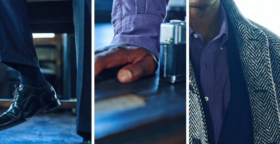 A close-up of a man's hand and stylish outfit details.