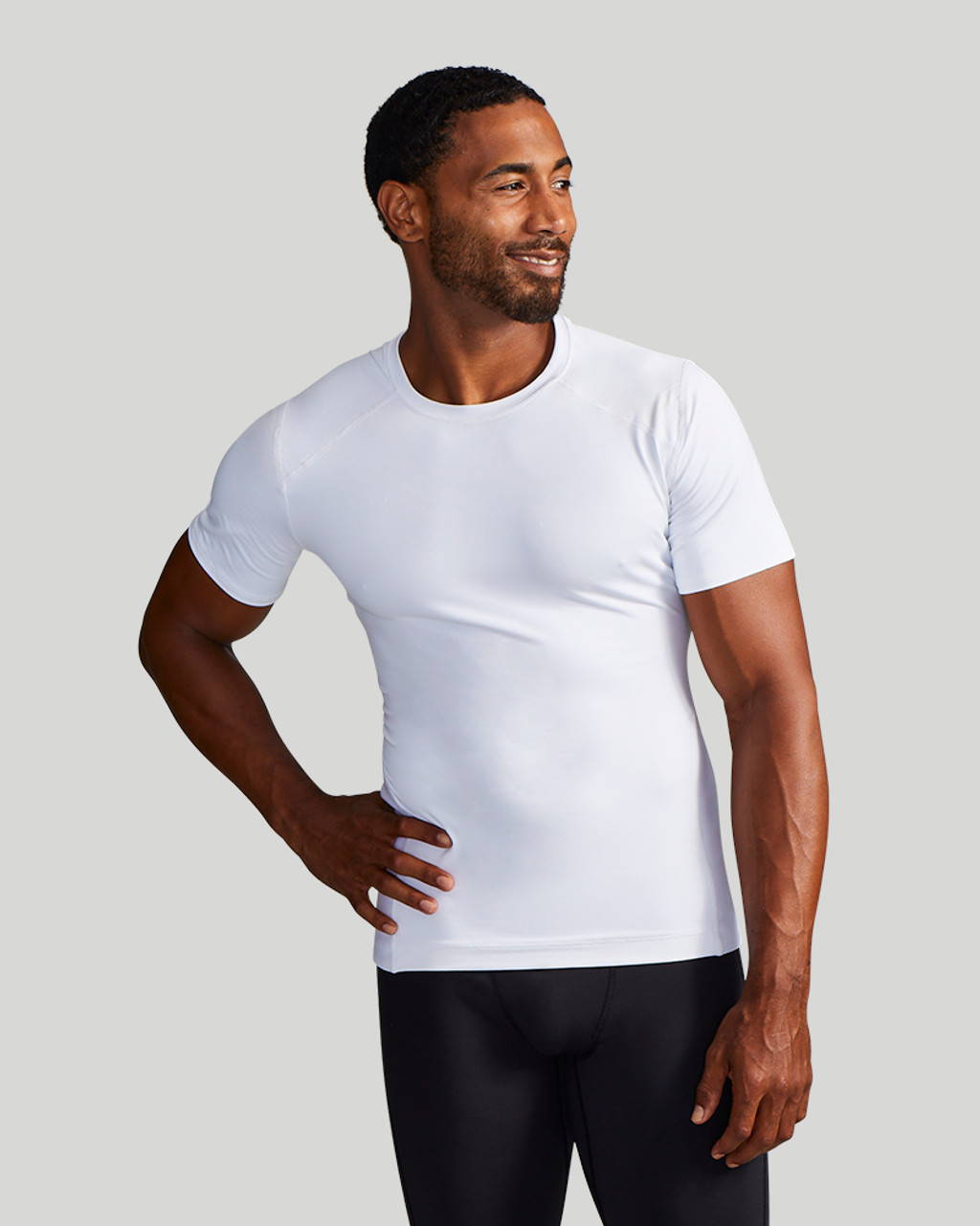 A man wearing a white Tommie Copper Lower Back Support Shirt