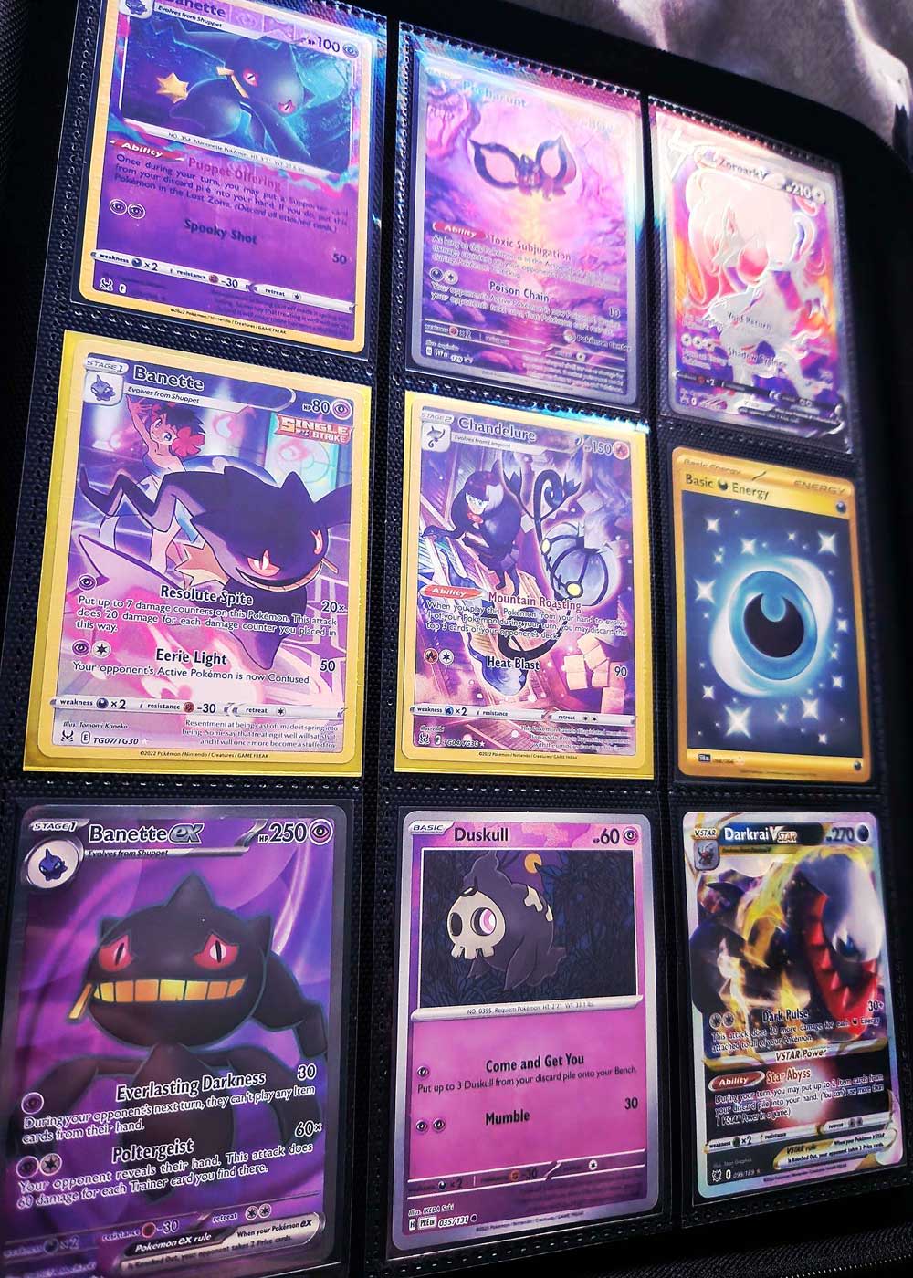 A collection of Pokémon cards featuring ghost-type characters and purple backgrounds.
