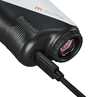 Close-up of a Bushnell A1 Slope device with a charging cable.