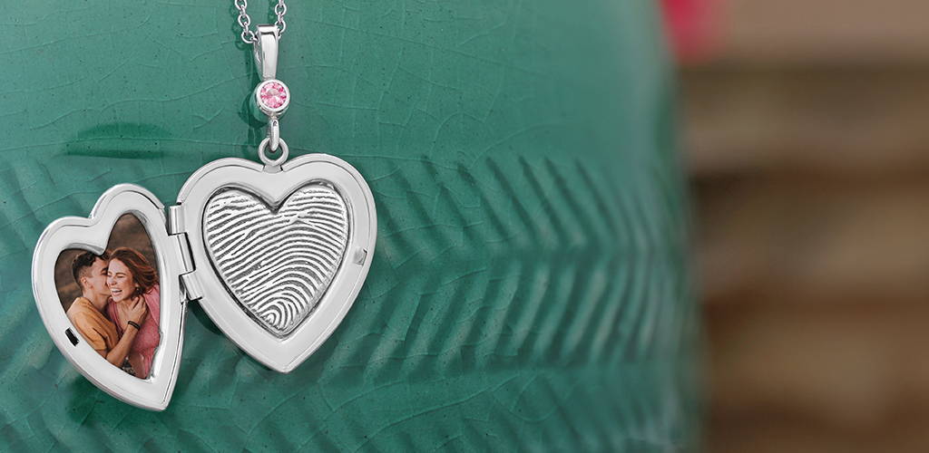 open sterling silver heart shaped locket with picture and engraved fingerprint on the inside
