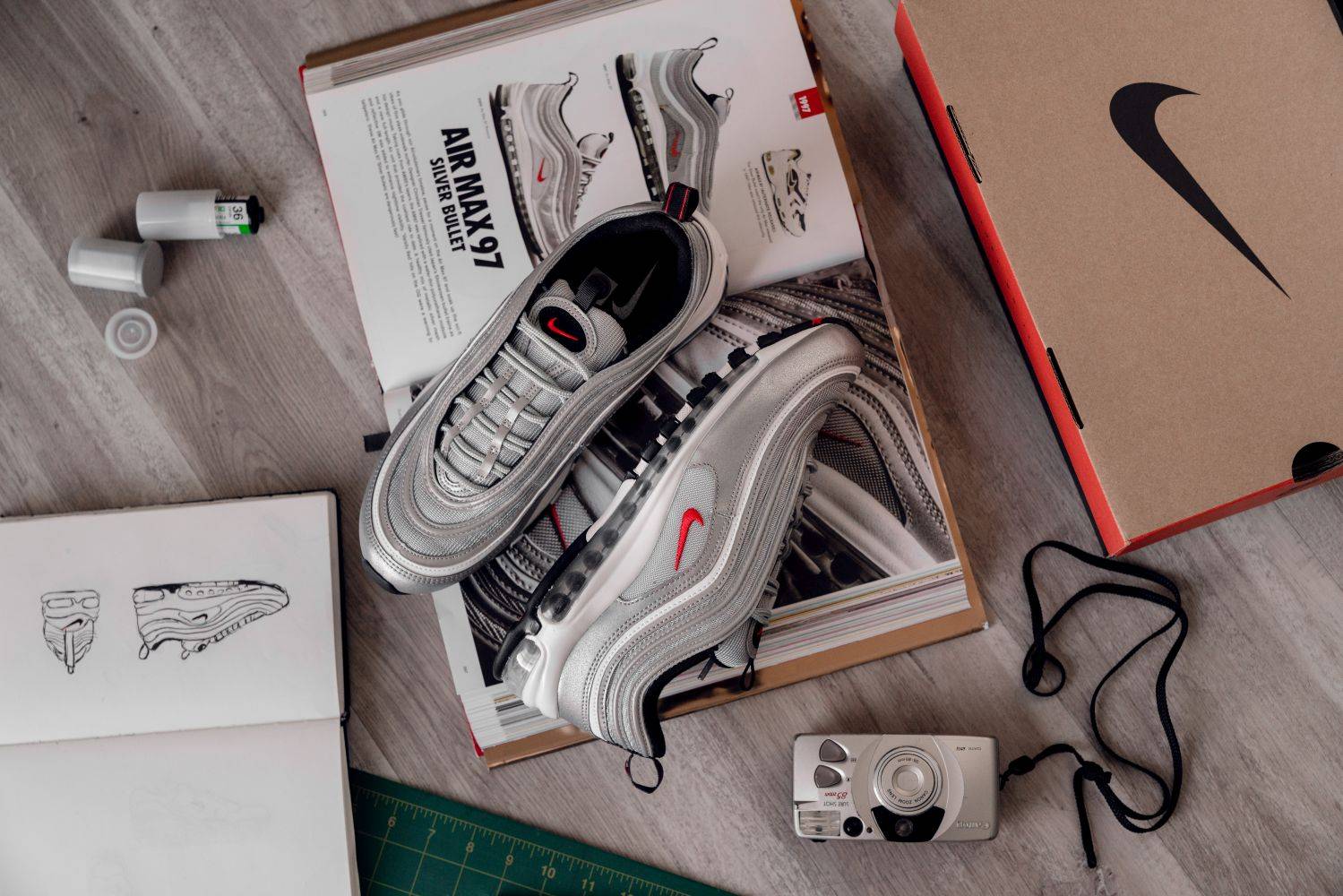 nike air max 97 silver bullet on top of table