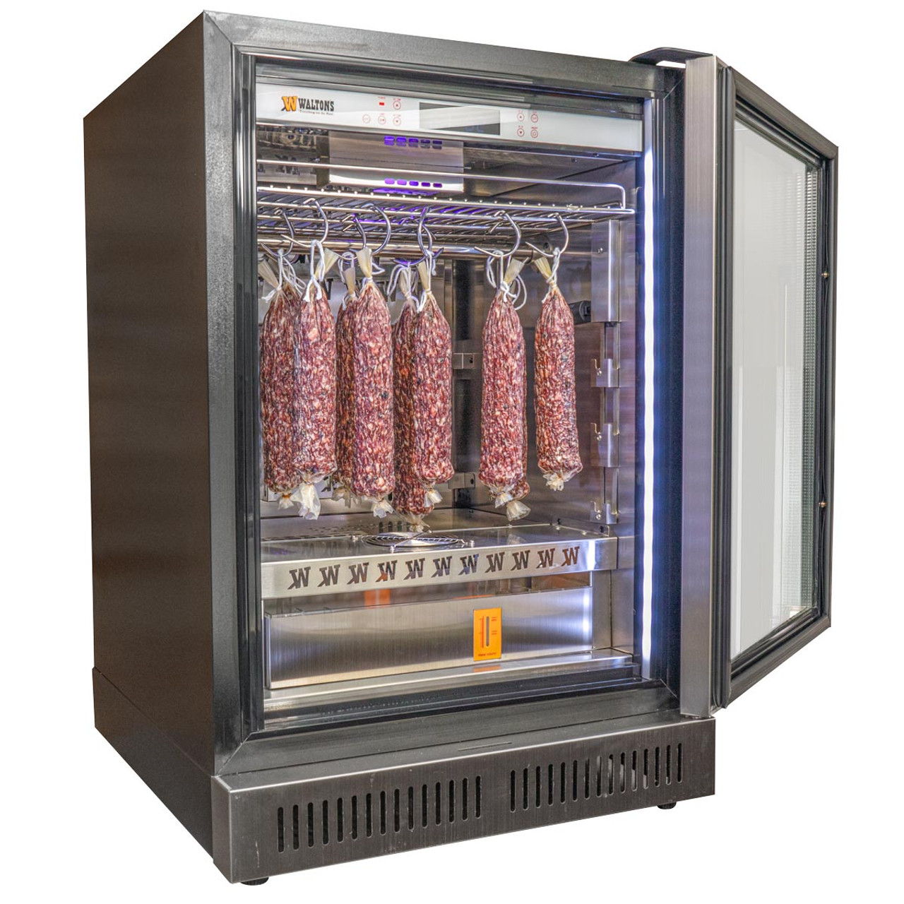 A meat curing fridge with hanging salami inside.