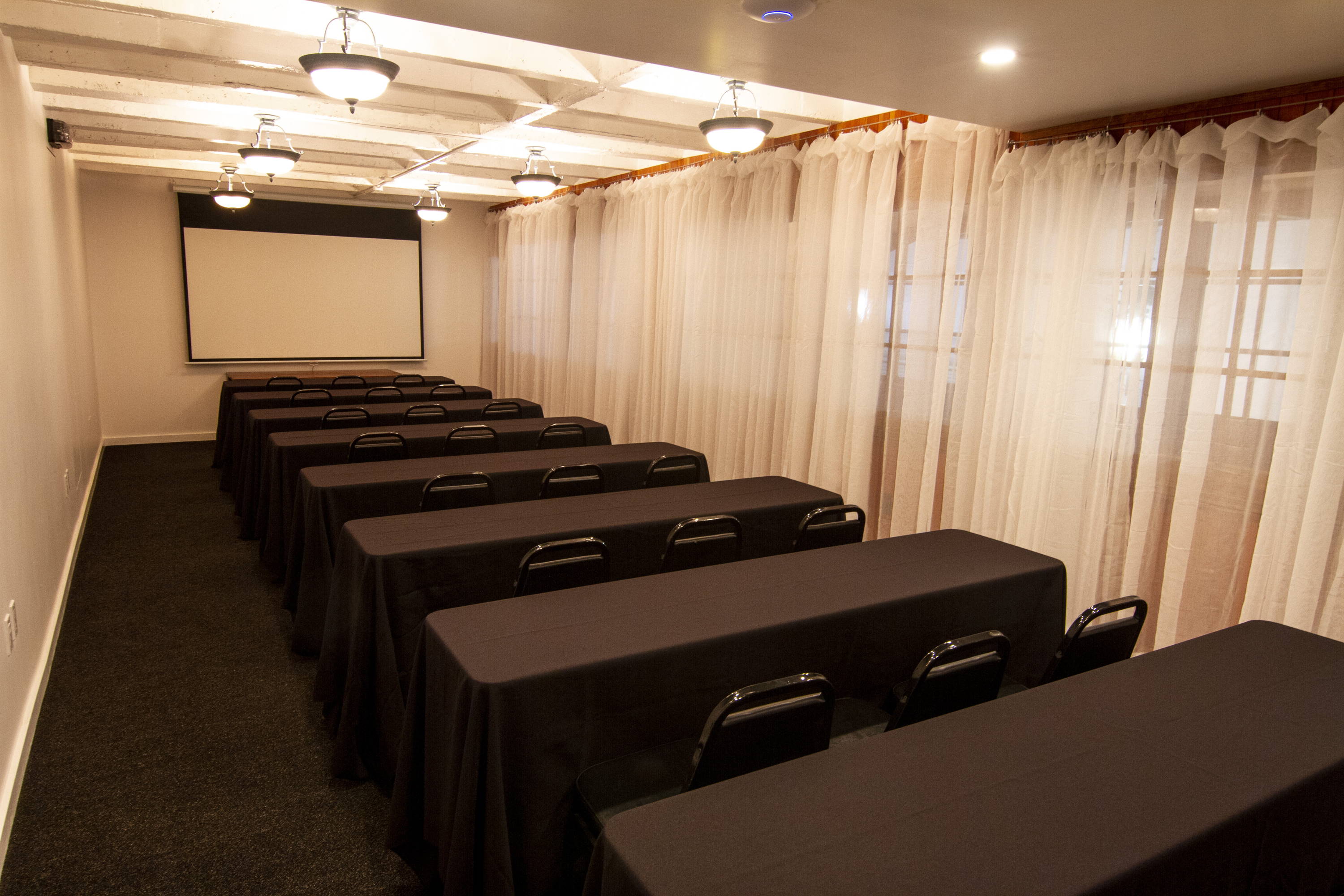 conference room style seating at the buddy suite at theboxsf with projector screen