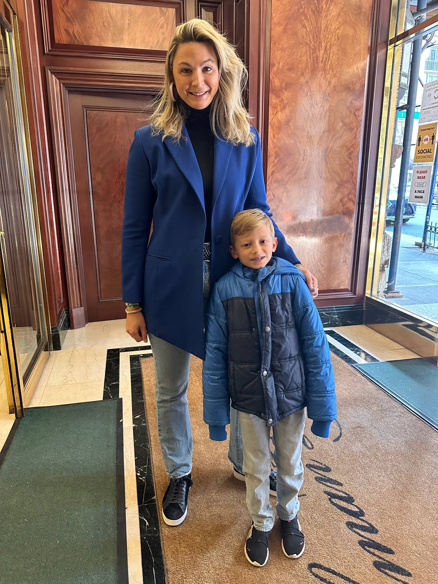 Sunny wearing blue silk lined blazer with her son in New York City