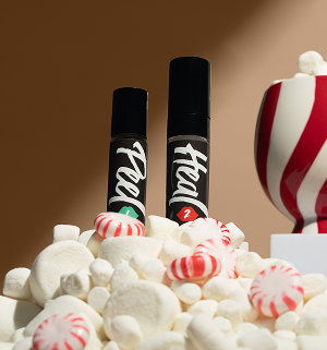 Smiling woman applying Lip Heal in a beauty setting.