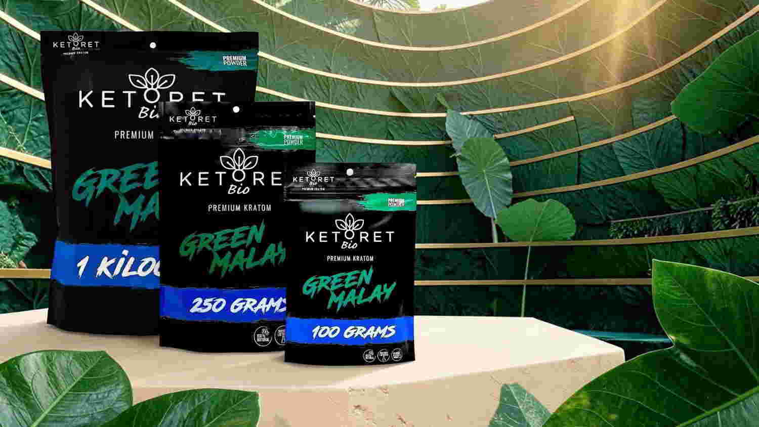 Three packets of green powder on a table surrounded by tropical leaves.