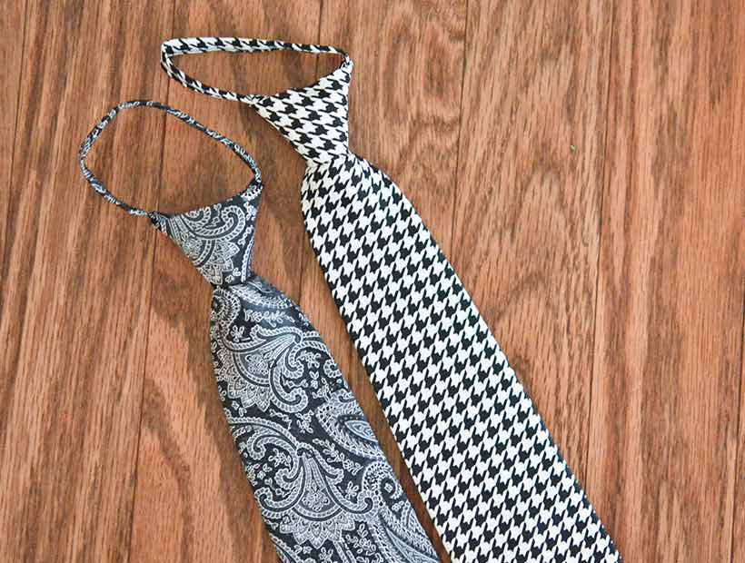 Black pattern pre-tied zipper ties displayed flat on a wood floor