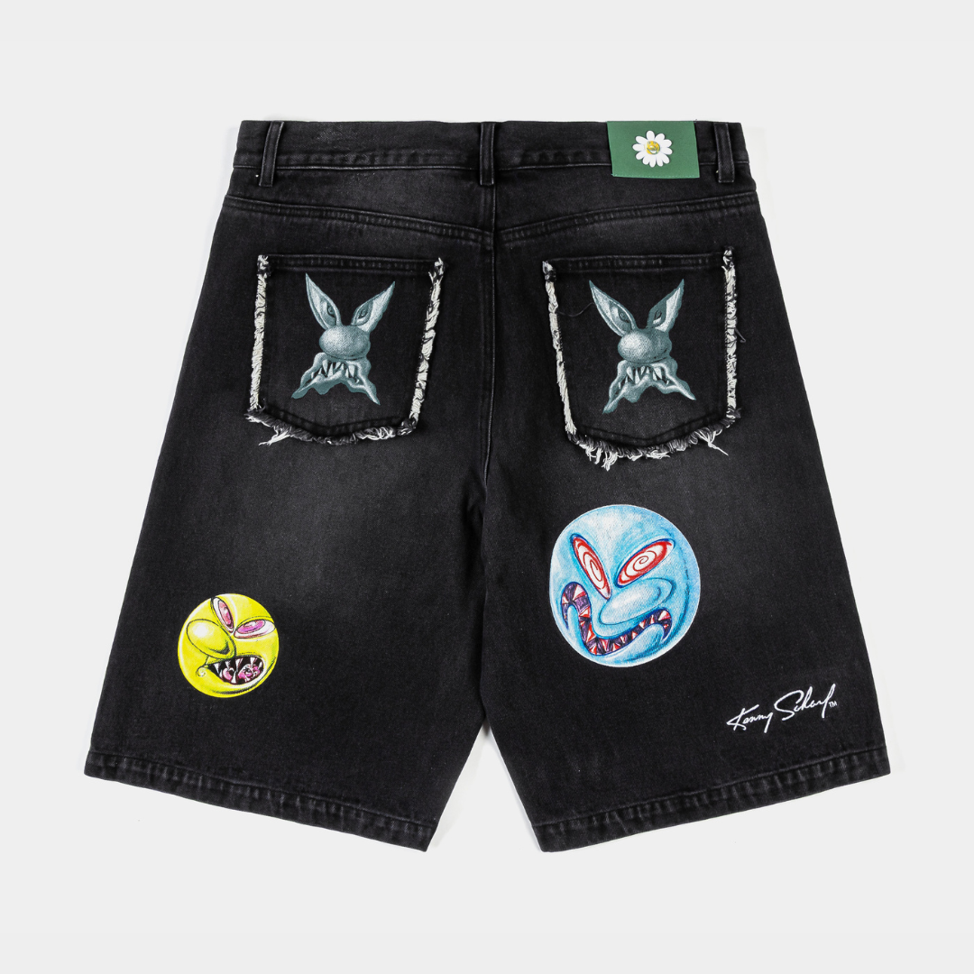 Black denim shorts with colorful patches and designs.