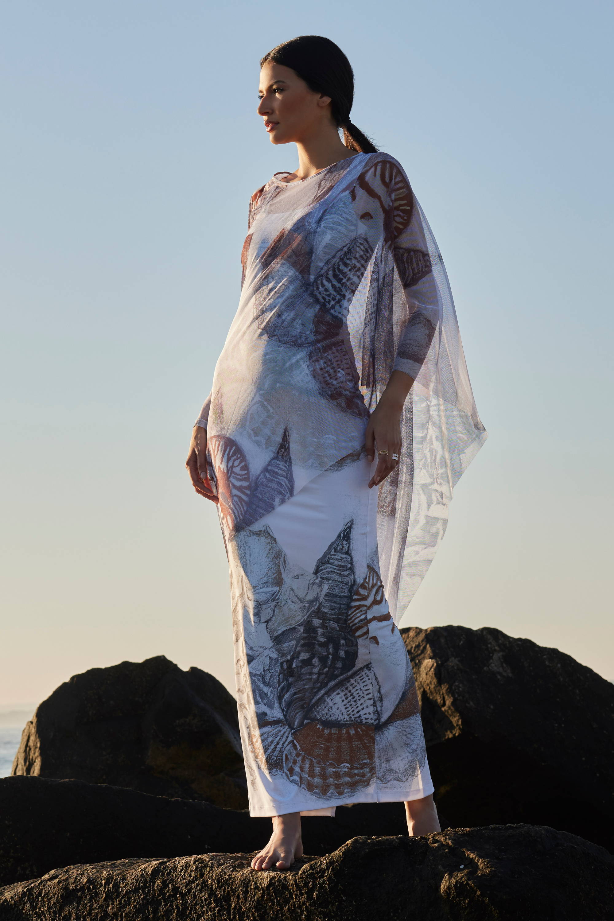 Woman wearng mesh kaftan cover up over long stretch knit dress by Ala von Auersperg