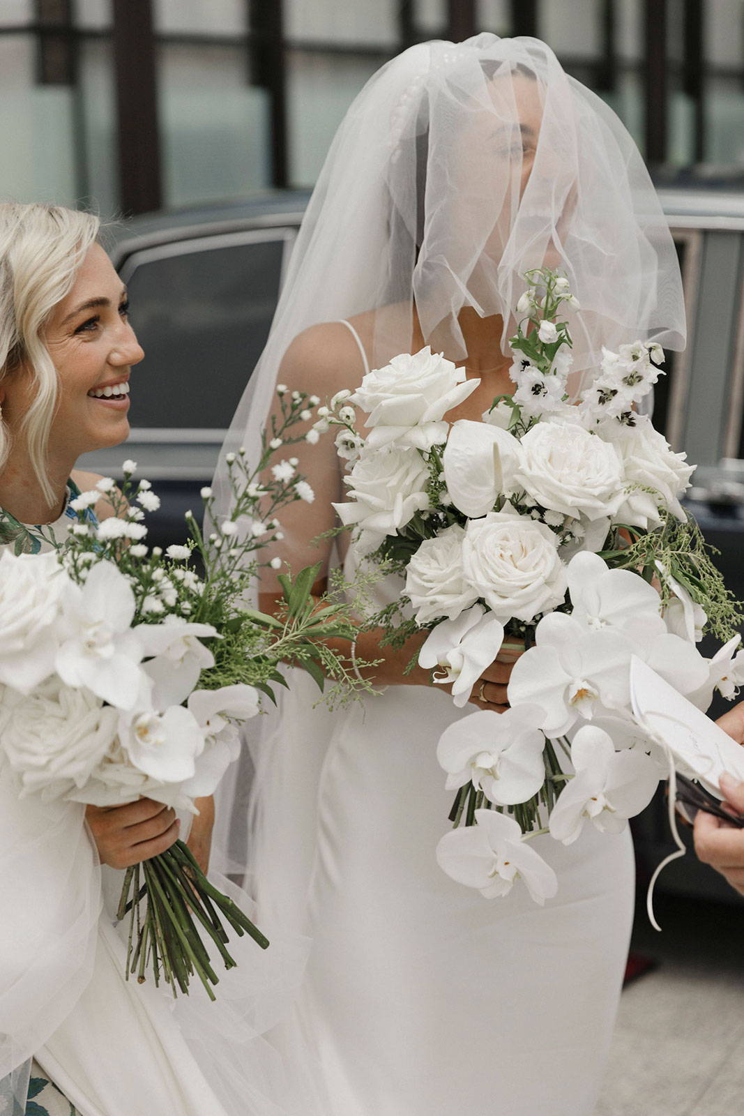 Bride laughing under veil