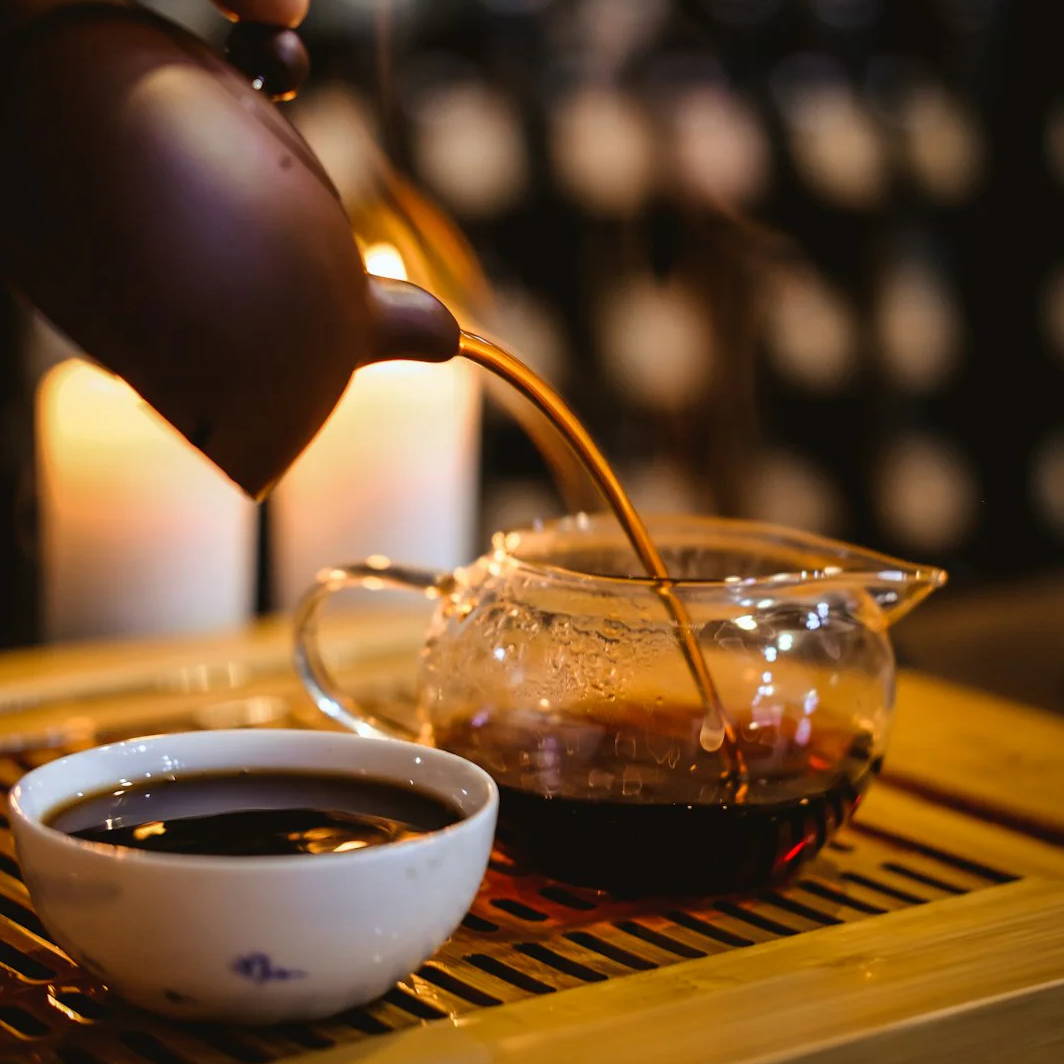 person holding brown teacup