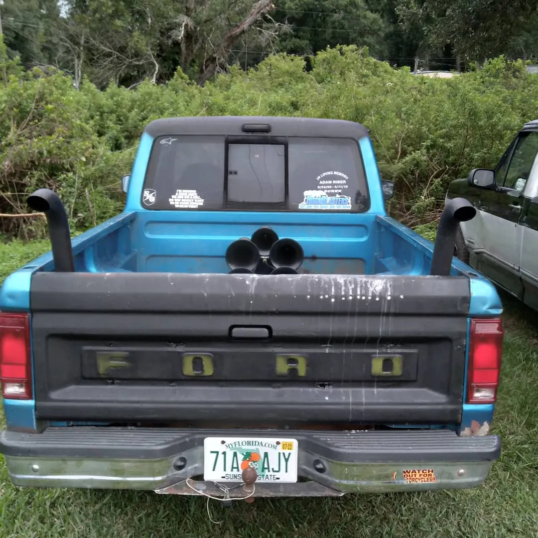 Close-up five-bell black train horn kit mounted on front wall of Caleb's blue Ford Ranger truck bed photo 2