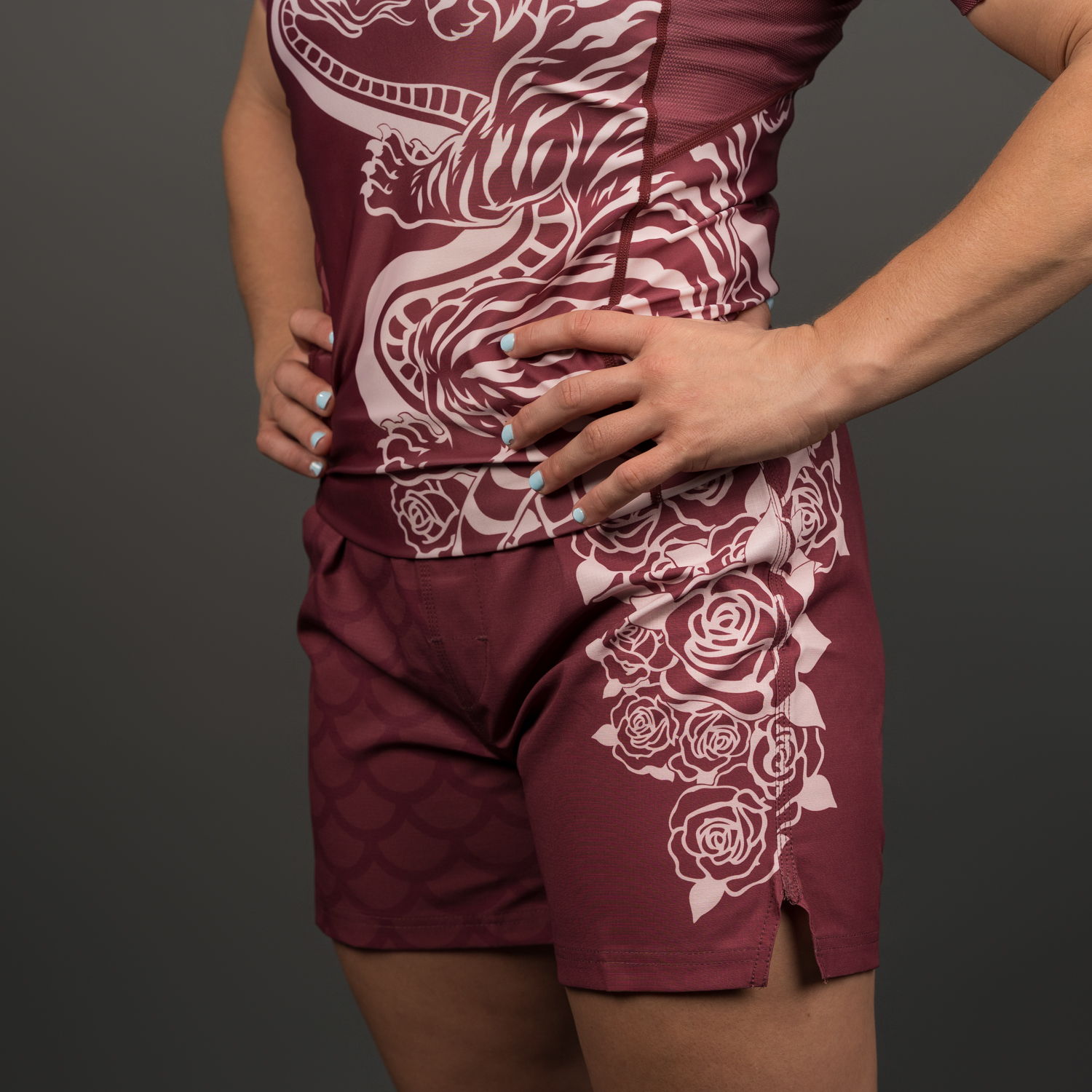 Person wearing maroon athletic outfit with intricate white patterns.