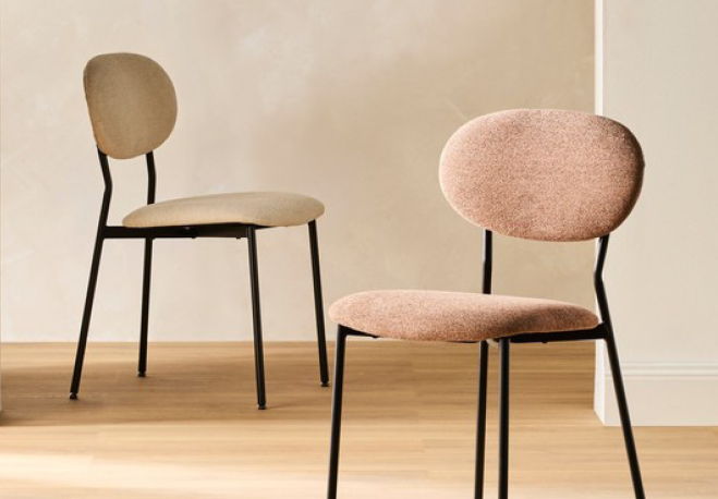 Two modern chairs with soft cushions on a wooden floor.