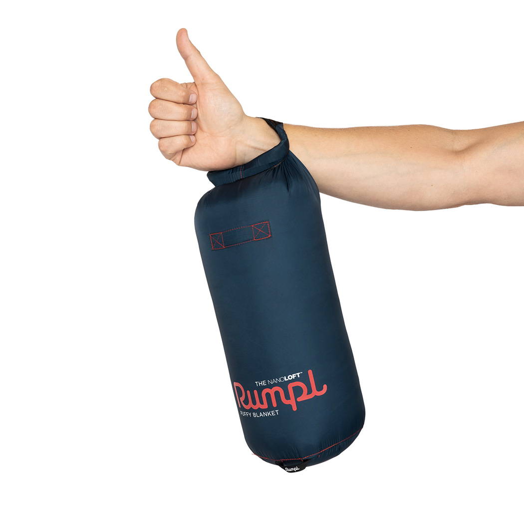 Thumbs up hand holding a Rumpl NanoLoft Puffy Blanket