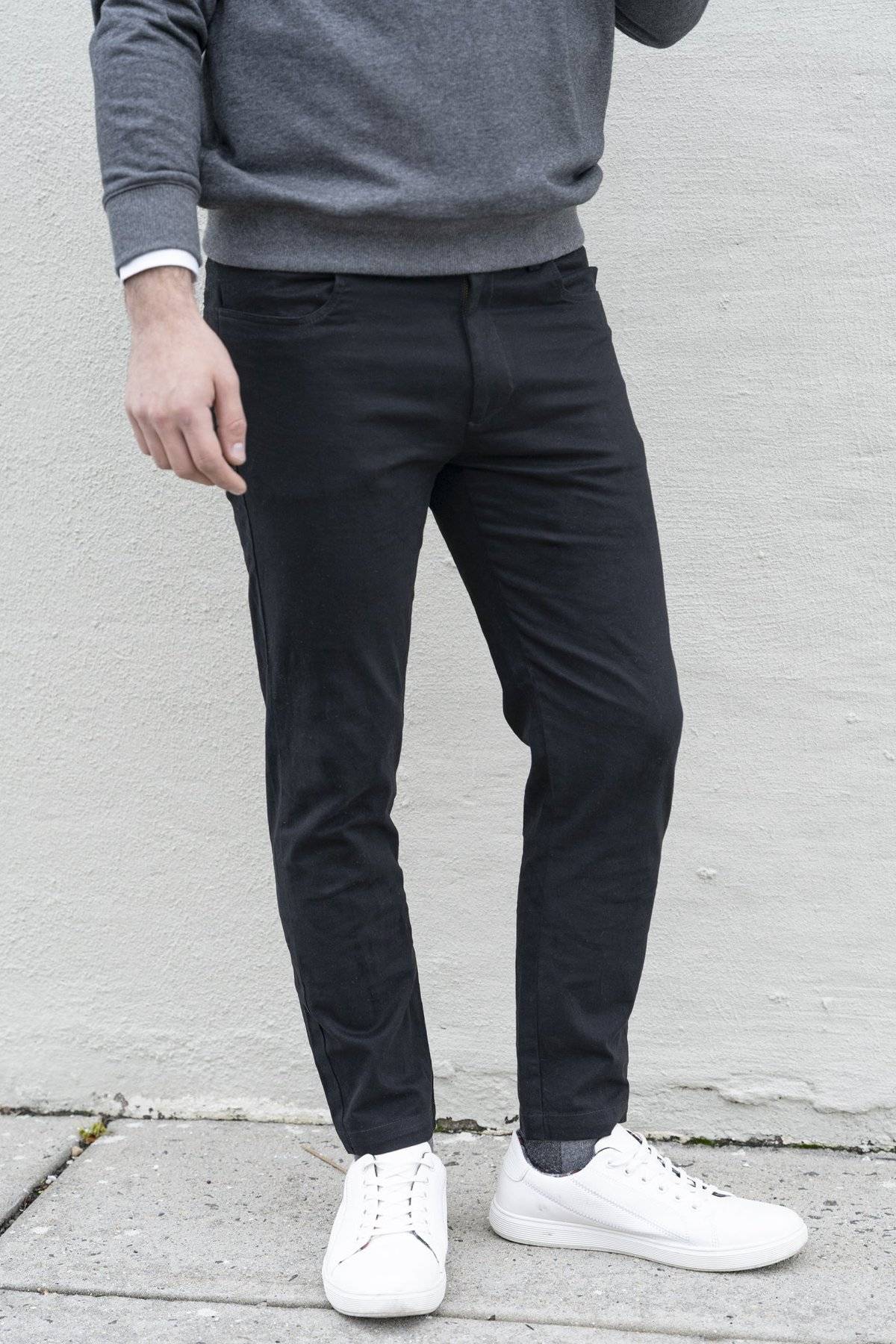 Man standing wearing white shoes, and black chinos from under510.com