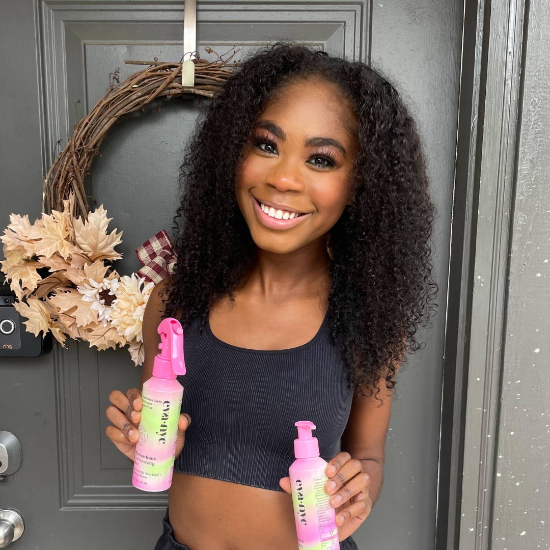 Girl holding Eva NYC curly hair products