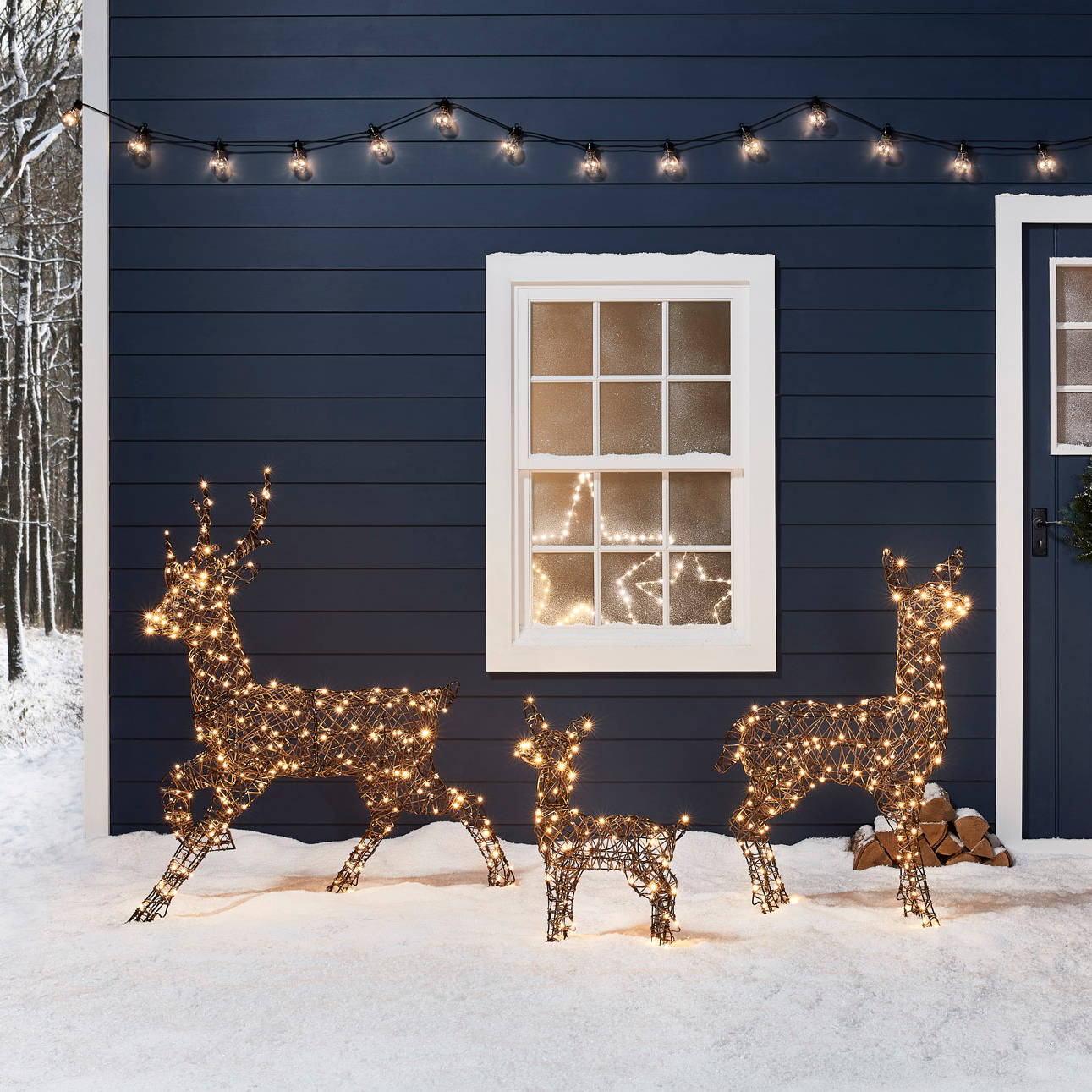 Light up reindeer family outdoor christmas figures illuminated outside a snowy winter cabin