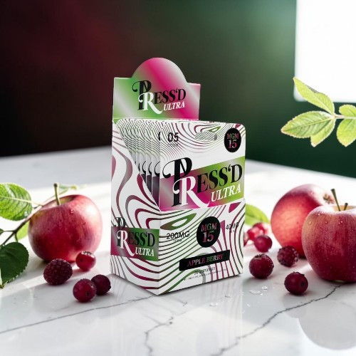 Box of Pressed juice with apples and cherries on a marble surface.