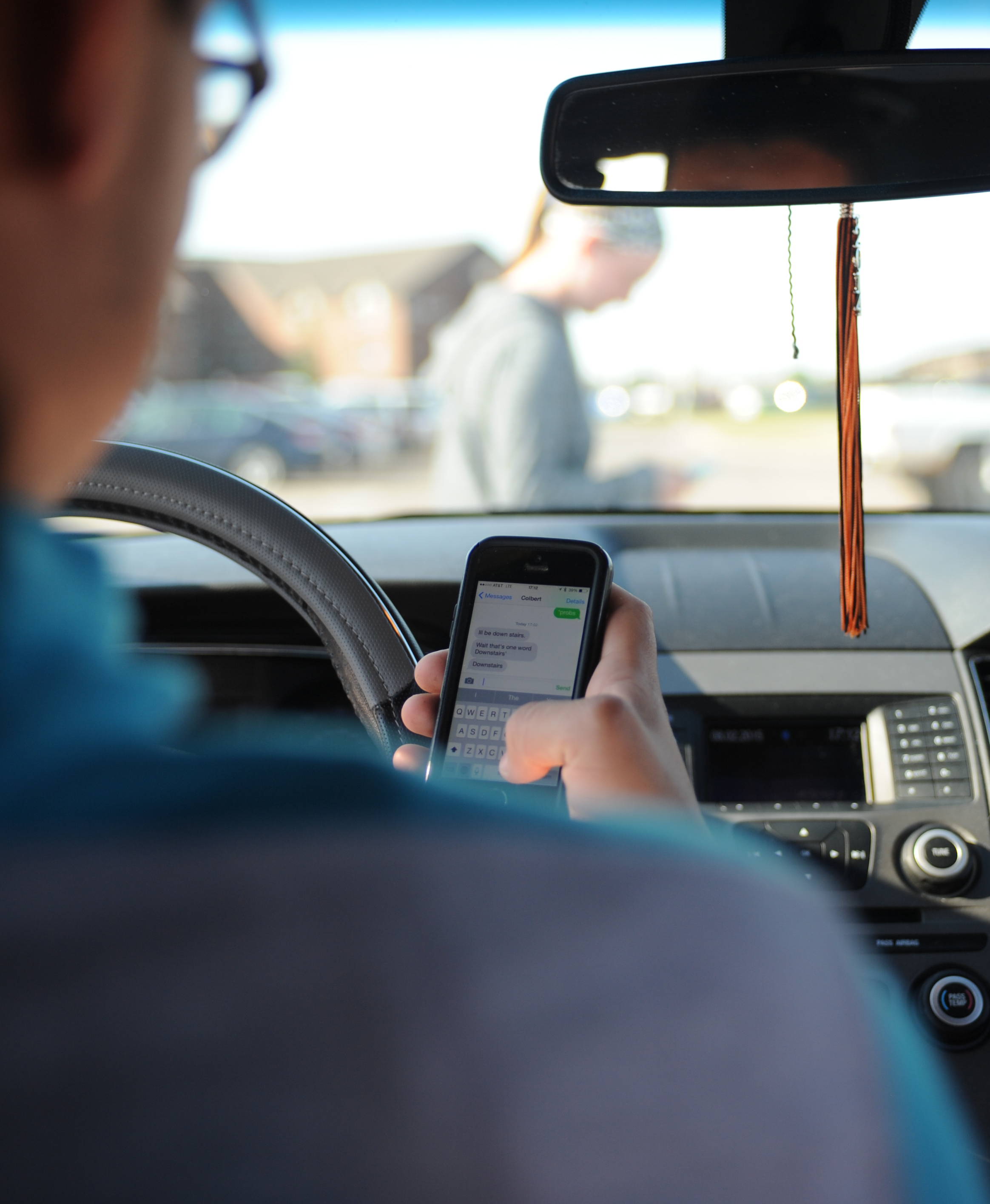 A driver texting while driving their vehicle.