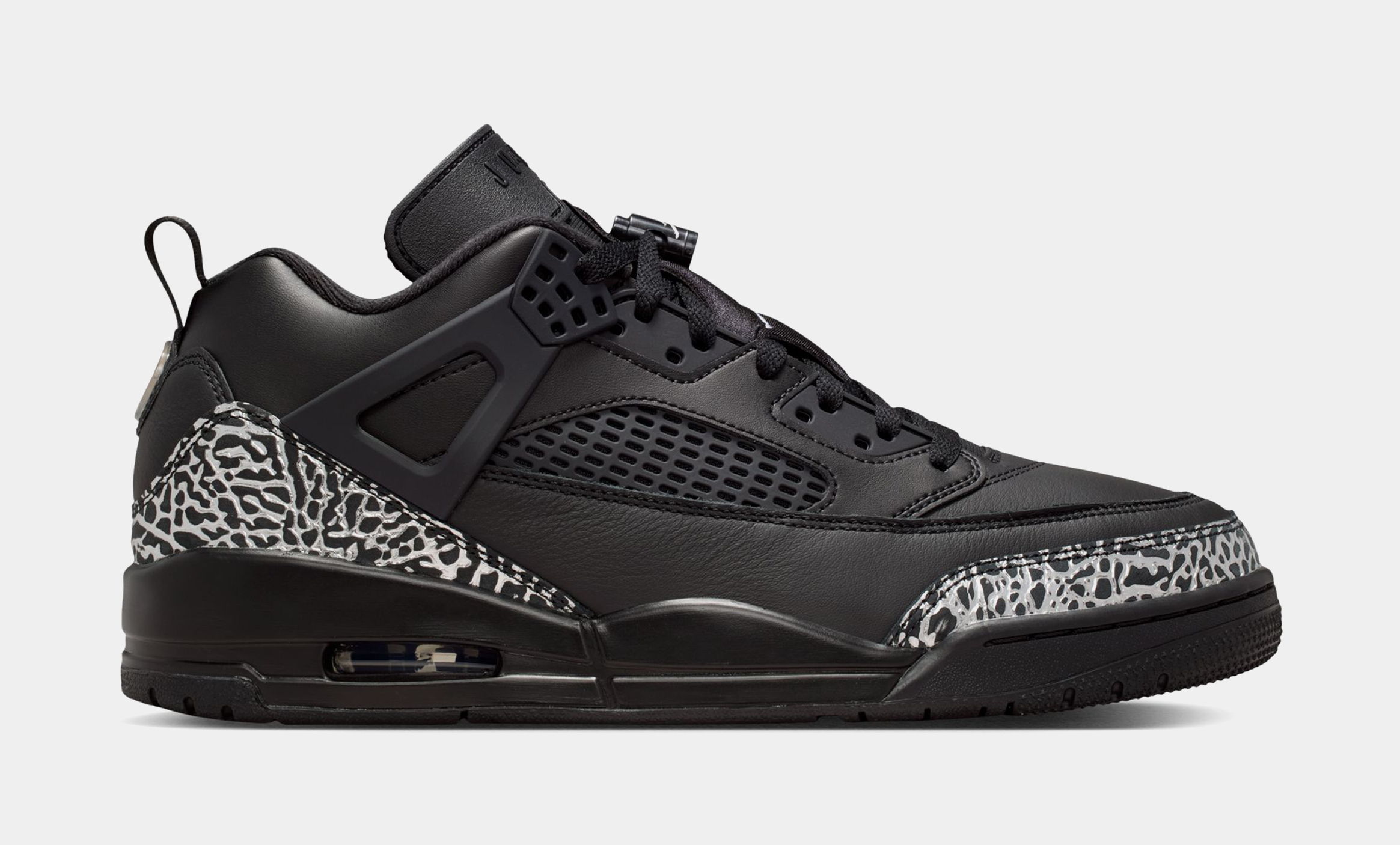 Black sneakers with a patterned design on the heel.