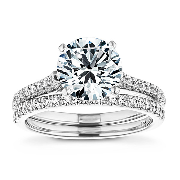 a stunning white gold wedding set with a diamond accented solitaire and diamond accented band