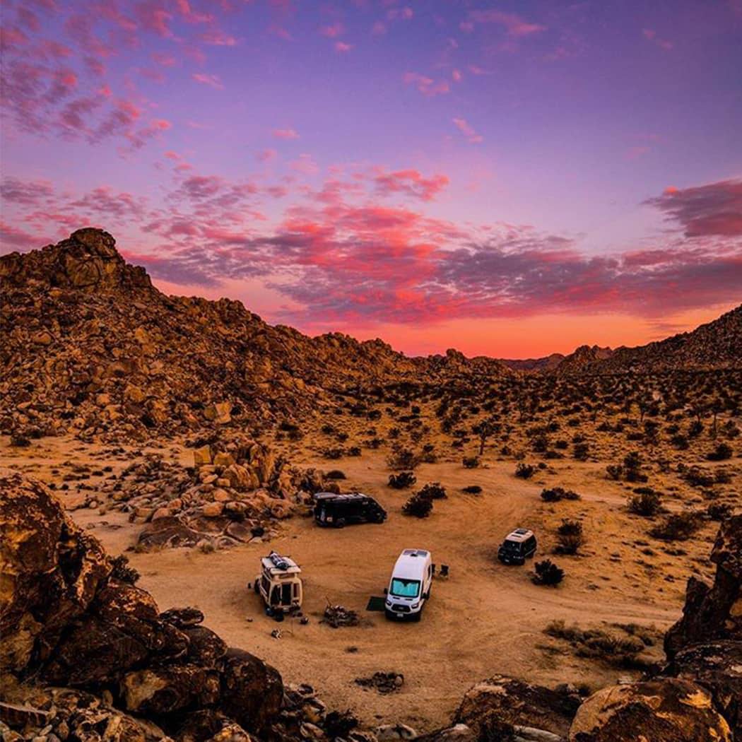 Desert sunset and two camper vans