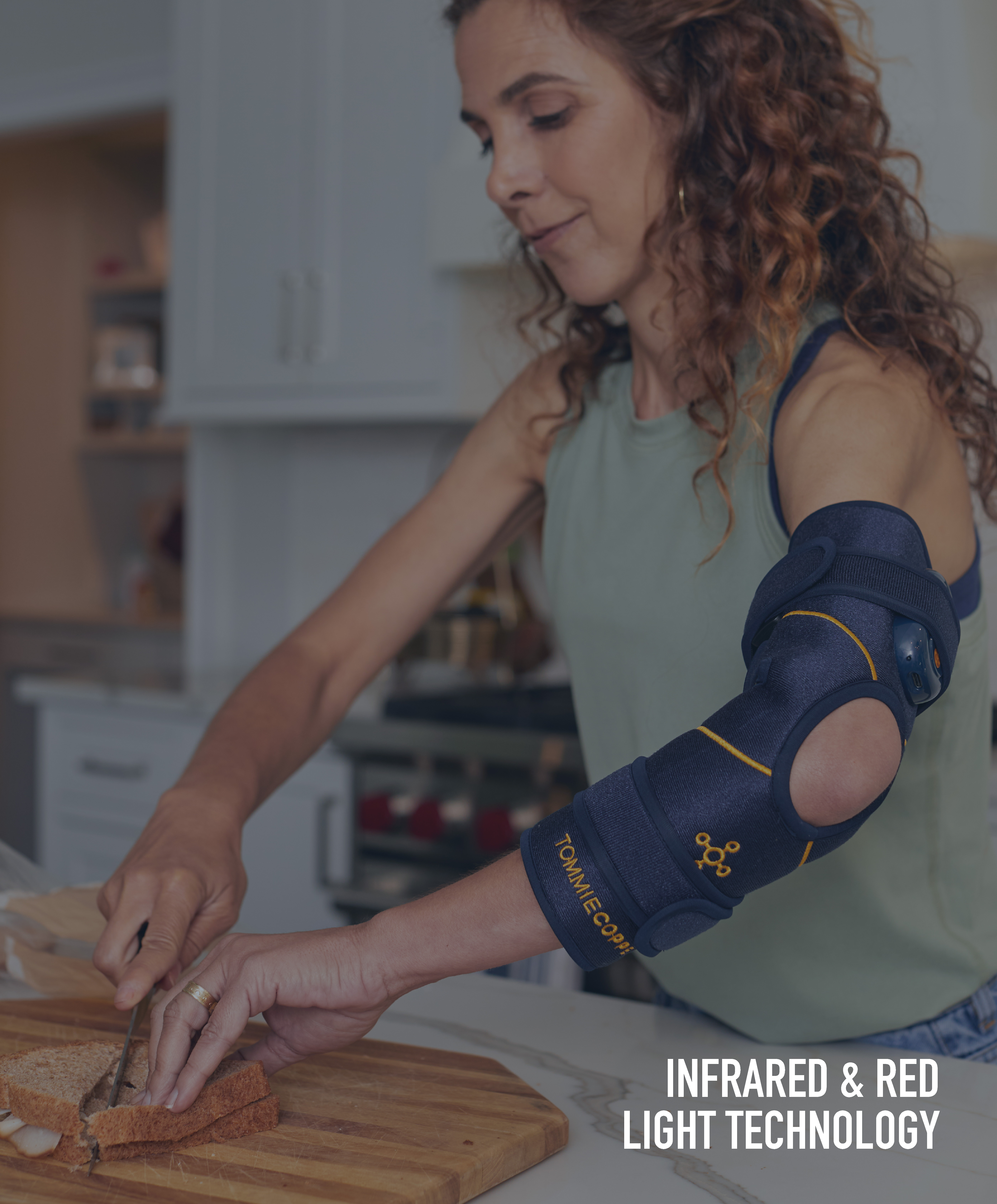 Woman making school lunch using Infrared & Red Light Therapy on her elbow