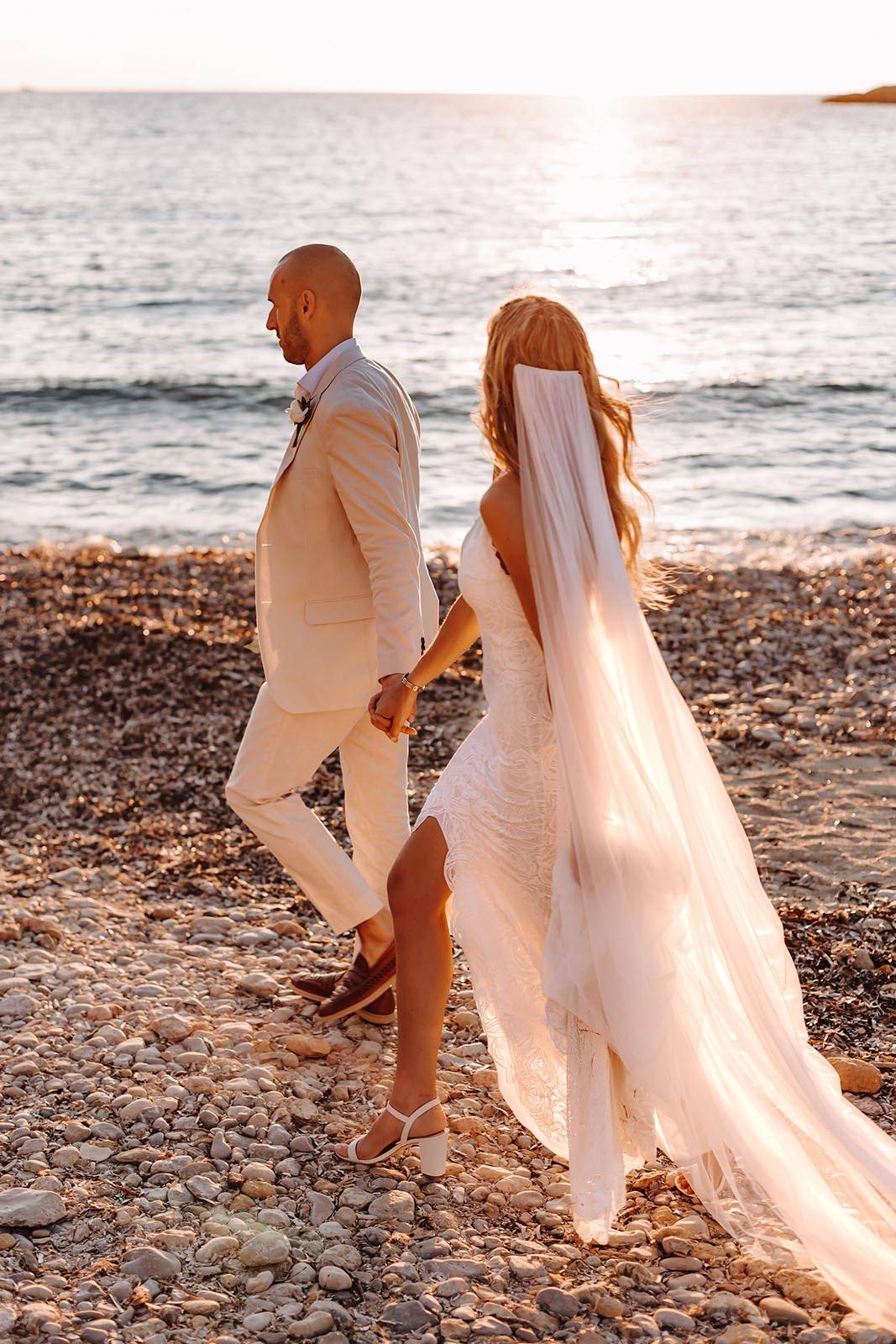 Bride and groom, walking on the beach