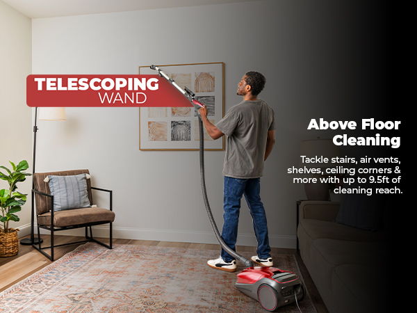 Person using a telescoping wand for above floor cleaning.