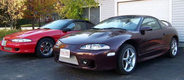 Front three-quarter maroon 1999 Mitsubishi Eclipse front-mount intercooler driveway red Eclipse Shocker XL train horn featured customer install gallery photo 1