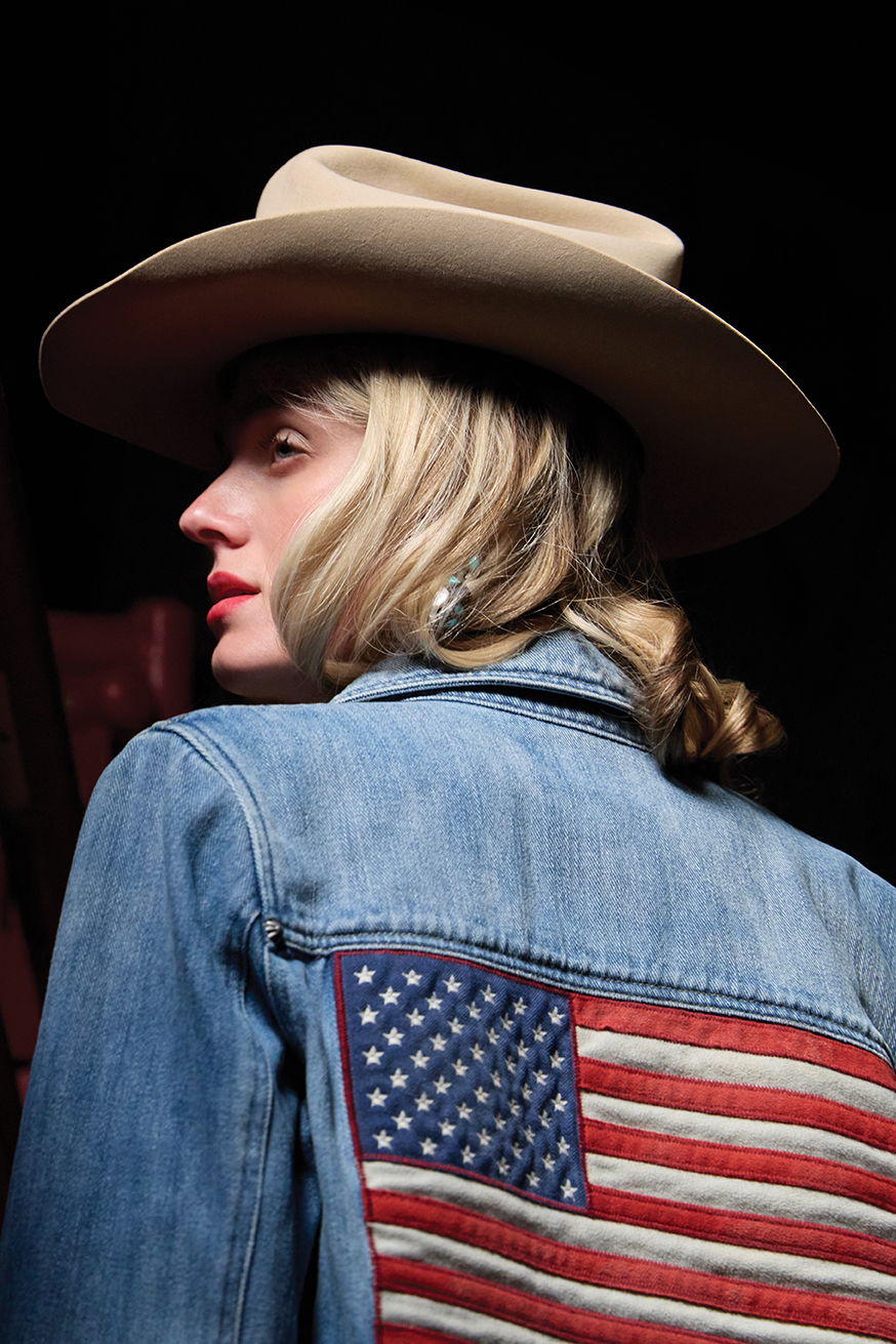 Haley wearing the Old Glory and Grit Jacket with a vintage Double D Ranch hat.